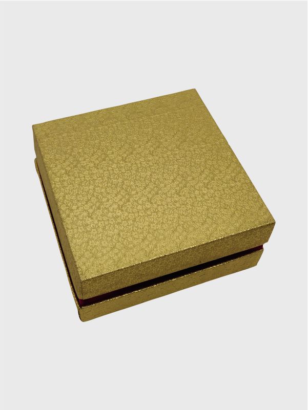 Isometric view of a handcrafted greyboard shoulder neck box with gold Rexene wrapping and a contrasting dark pink neck for an elegant finish.