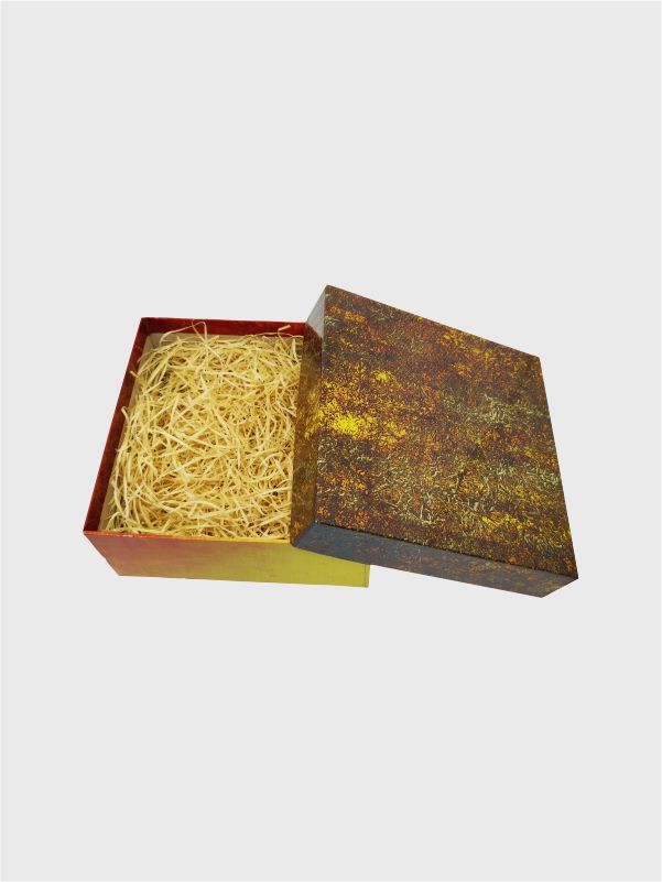 Lid leaning on the side of the luxury gift box highlighting the textured stony print